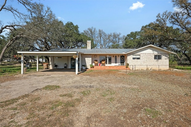 view of front of property featuring a porch and a carport