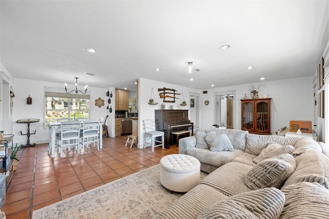 living room featuring light tile patterned floors and an inviting chandelier