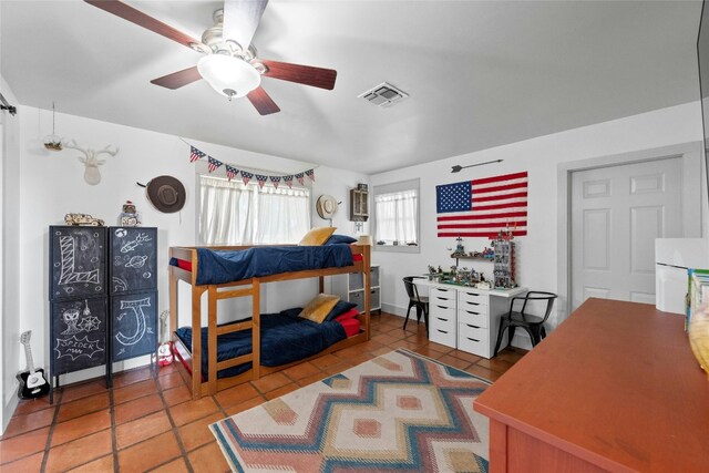 bedroom with ceiling fan and tile patterned flooring