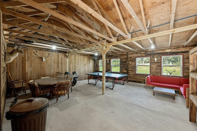 game room with wooden walls and lofted ceiling