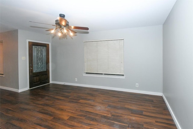 unfurnished room with ceiling fan and dark hardwood / wood-style flooring