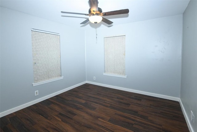 spare room featuring dark hardwood / wood-style flooring and ceiling fan