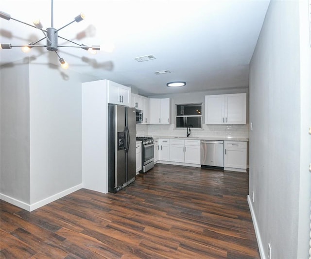 kitchen with white cabinets, stainless steel appliances, dark wood-type flooring, and sink