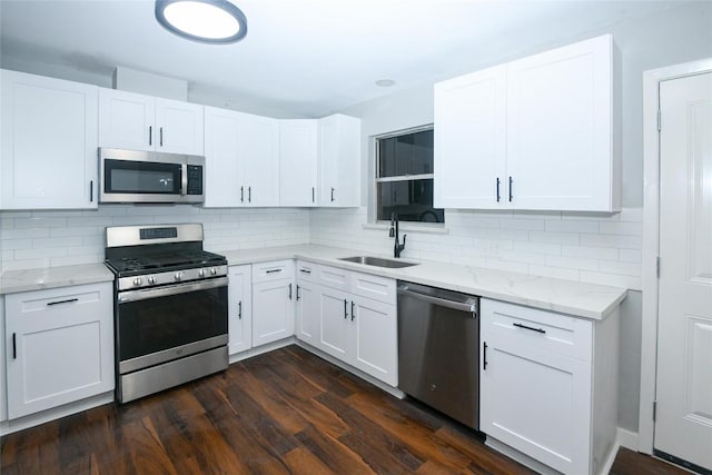 kitchen with white cabinets, appliances with stainless steel finishes, and sink