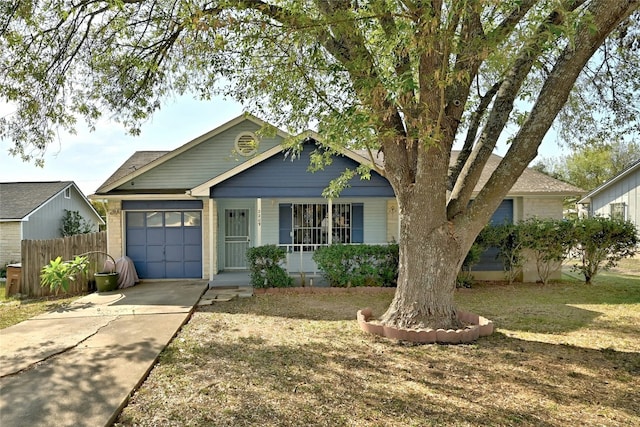 view of front of property featuring a garage and a front lawn