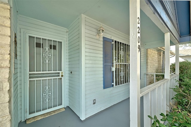 view of exterior entry with covered porch