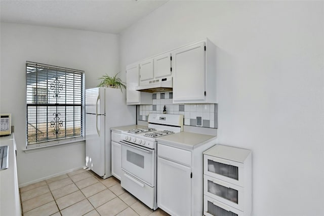 kitchen featuring white cabinetry, premium range hood, white appliances, decorative backsplash, and light tile patterned floors