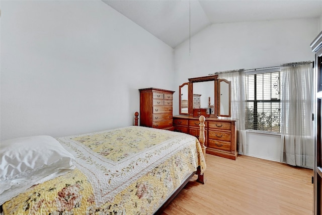 bedroom featuring hardwood / wood-style floors and vaulted ceiling