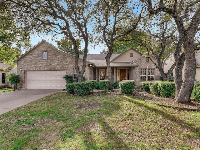 view of property featuring a garage and a front lawn