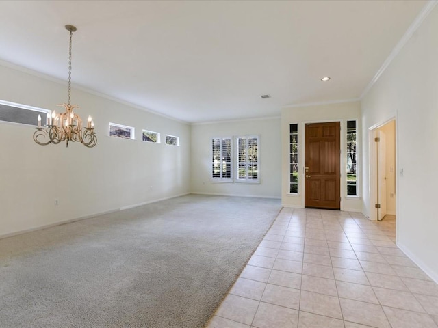 entrance foyer with a notable chandelier, light tile patterned flooring, and crown molding