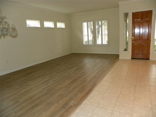 foyer entrance featuring crown molding and light wood-type flooring