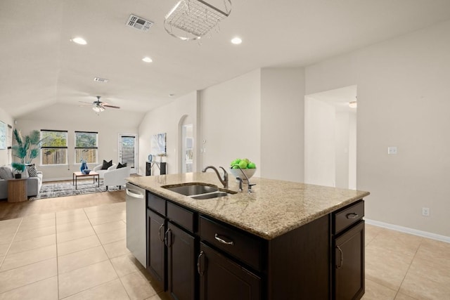 kitchen featuring stainless steel dishwasher, ceiling fan with notable chandelier, sink, a center island with sink, and lofted ceiling