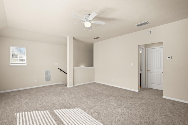 empty room featuring light carpet, ceiling fan, and lofted ceiling