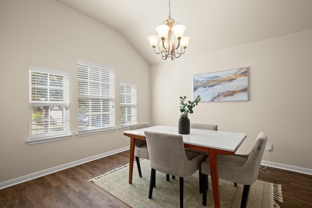 dining area with vaulted ceiling, dark hardwood / wood-style floors, and a notable chandelier