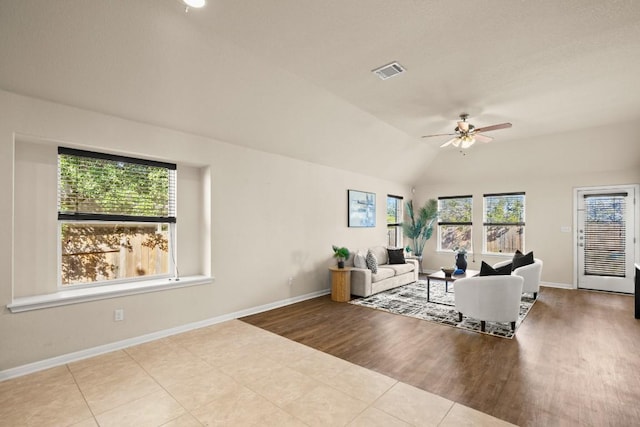 living room with light wood-type flooring, ceiling fan, and lofted ceiling