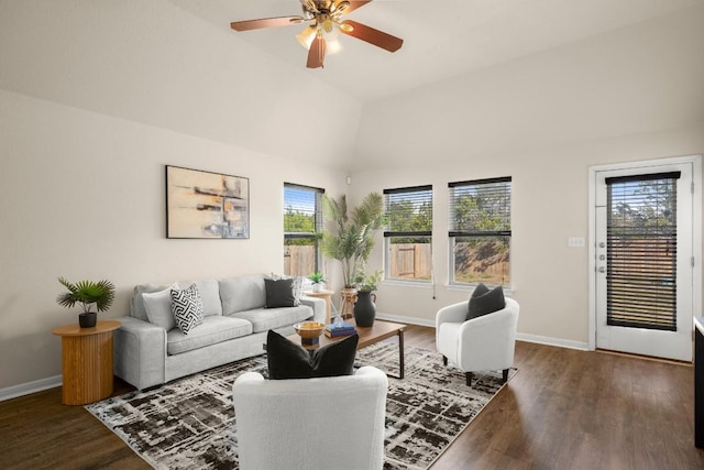 living room with dark hardwood / wood-style flooring, ceiling fan, plenty of natural light, and vaulted ceiling