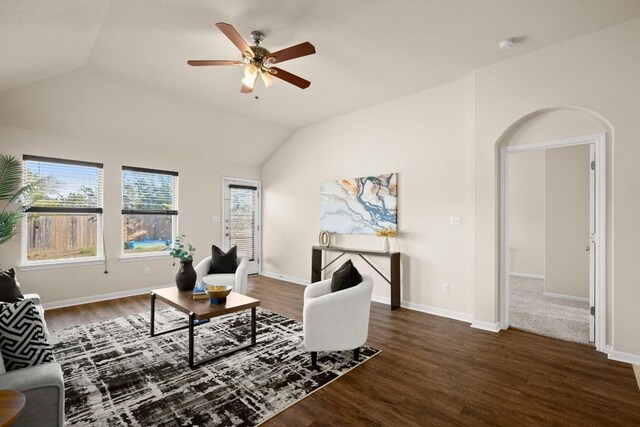 living room featuring ceiling fan, dark hardwood / wood-style flooring, and vaulted ceiling