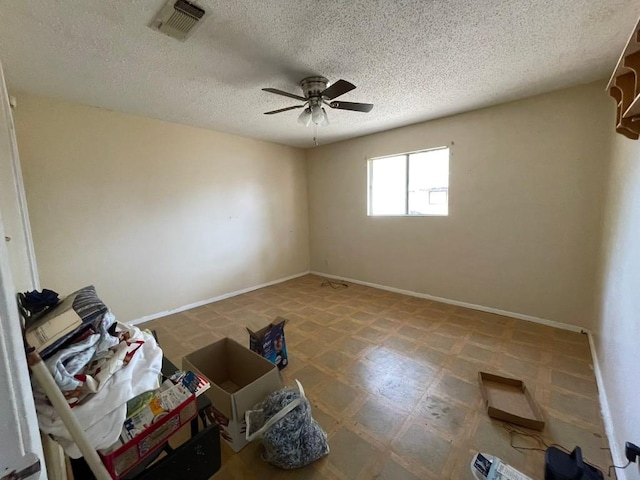 spare room featuring a textured ceiling and ceiling fan