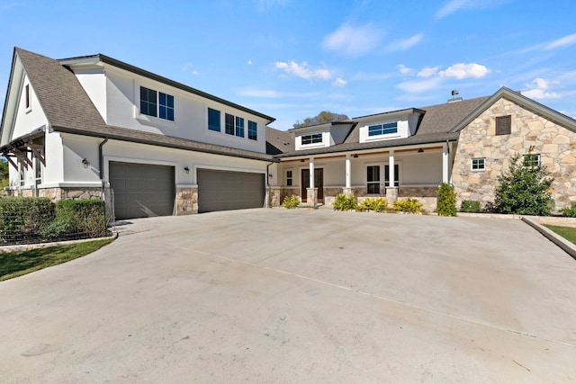 view of front of home featuring a porch and a garage