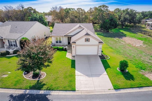 view of front of property with a garage and a front yard