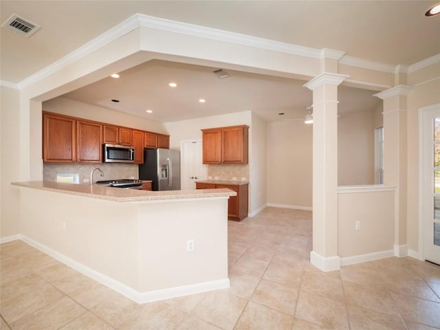 kitchen with kitchen peninsula, appliances with stainless steel finishes, backsplash, decorative columns, and light tile patterned flooring