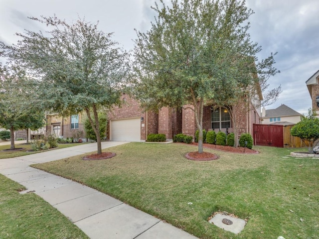 view of property hidden behind natural elements featuring a garage and a front lawn