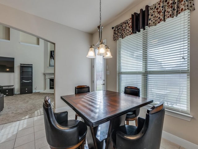 tiled dining room with plenty of natural light and a notable chandelier