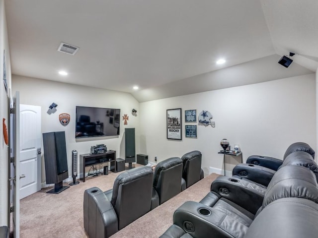 cinema room with light colored carpet and lofted ceiling