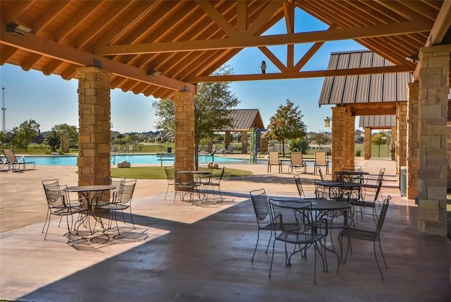 view of patio featuring a gazebo and a community pool