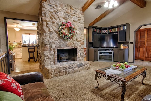 living room featuring light carpet, a fireplace, ceiling fan, and lofted ceiling with beams