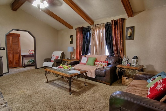 carpeted living room with vaulted ceiling with beams and ceiling fan