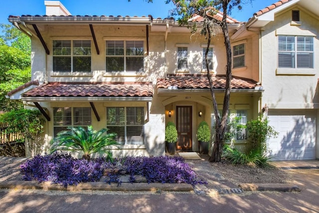 mediterranean / spanish-style home featuring a garage