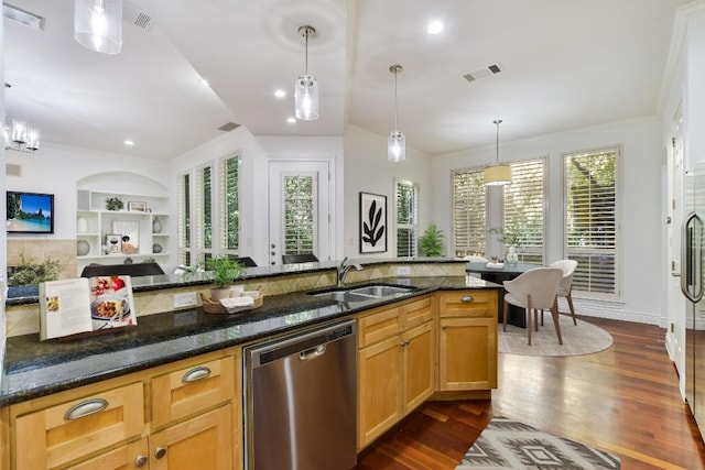 kitchen with pendant lighting, sink, dark stone countertops, built in shelves, and stainless steel dishwasher