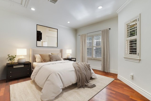 bedroom featuring wood-type flooring and crown molding