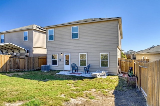 rear view of house with central AC unit, a yard, and a patio