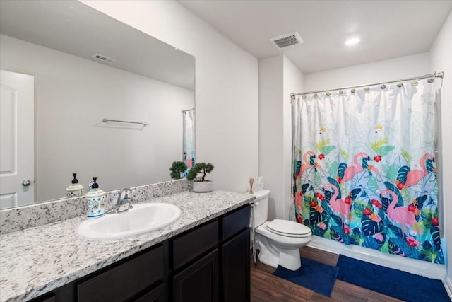 bathroom with vanity, hardwood / wood-style floors, a shower with shower curtain, and toilet