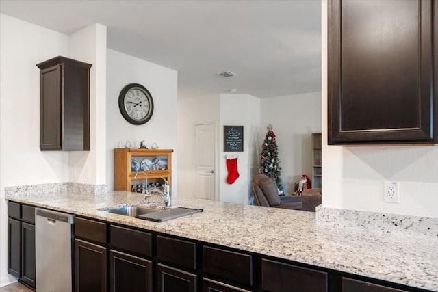 kitchen with stainless steel dishwasher, dark brown cabinetry, kitchen peninsula, and sink