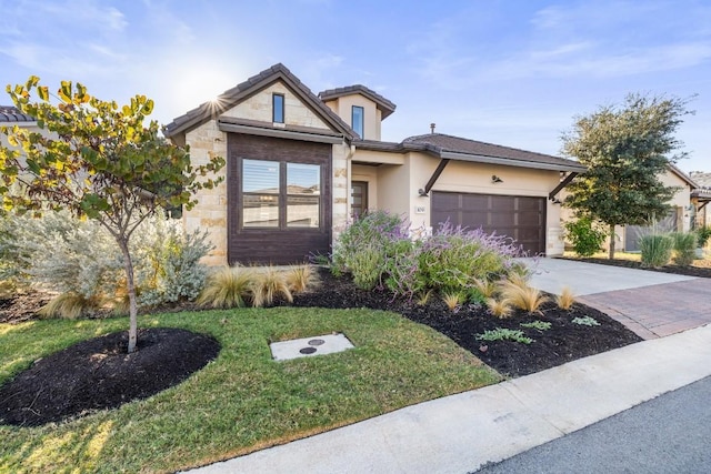 view of front of home featuring a garage and a front lawn