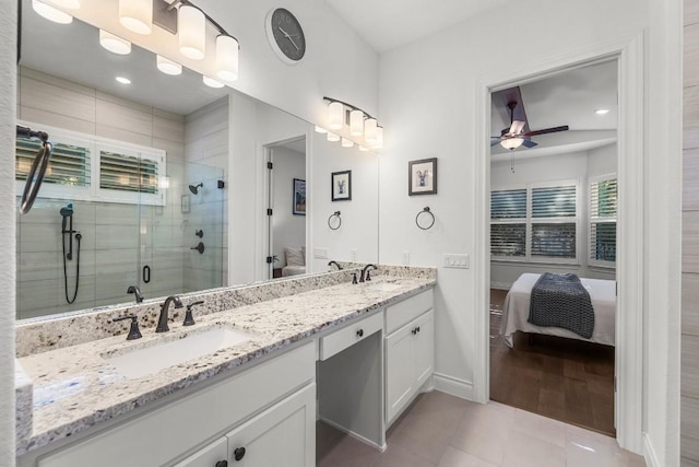 bathroom with hardwood / wood-style floors, ceiling fan, a shower with door, and vanity