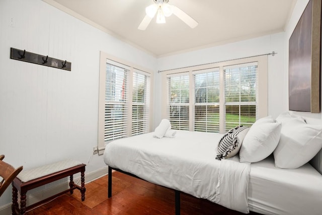 bedroom with ceiling fan and dark hardwood / wood-style floors