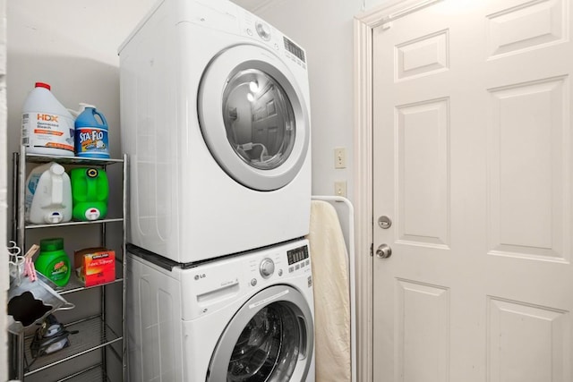 laundry area featuring stacked washer / drying machine