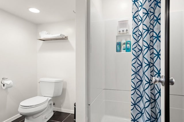 bathroom with tile patterned floors, toilet, and walk in shower