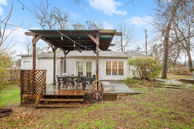 rear view of house featuring a pergola and a deck