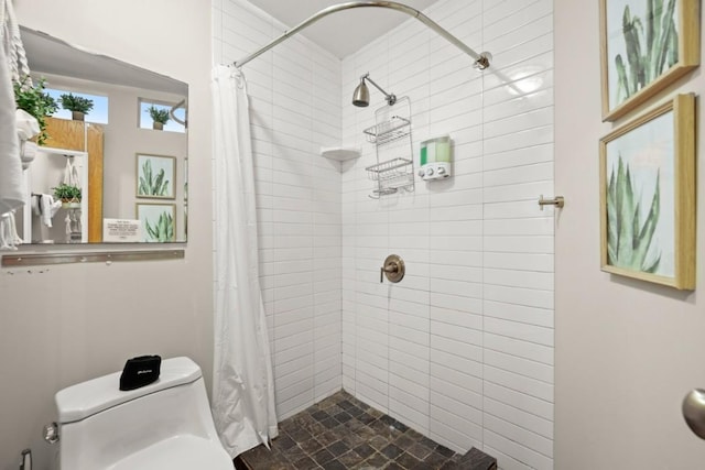 bathroom with a shower with shower curtain and toilet