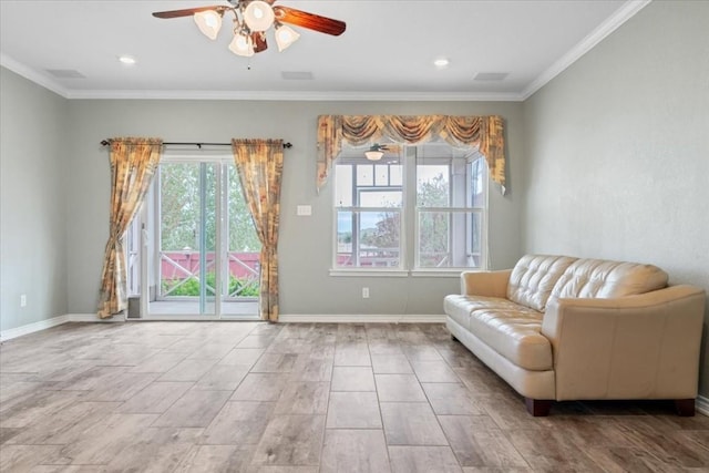 sitting room with baseboards, ornamental molding, and a ceiling fan