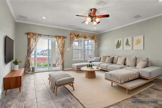 living room featuring light tile patterned floors, visible vents, baseboards, a ceiling fan, and crown molding