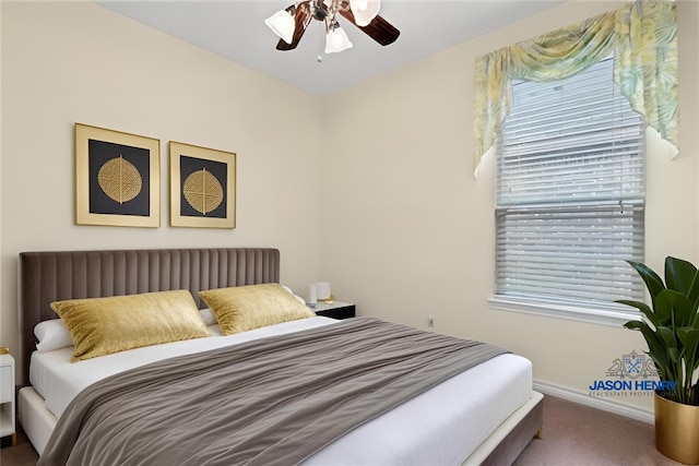 carpeted bedroom featuring ceiling fan and baseboards