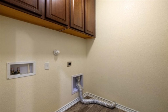 laundry room with hookup for a washing machine, hookup for an electric dryer, wood finished floors, baseboards, and cabinet space