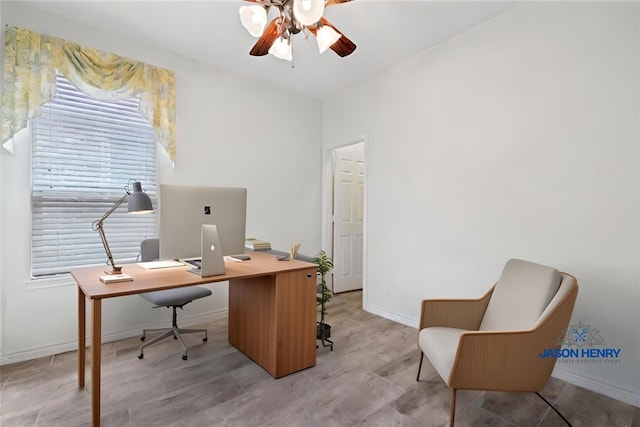 office space featuring ceiling fan, light wood finished floors, and baseboards