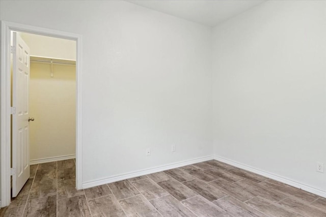 unfurnished room with baseboards and light wood-style floors